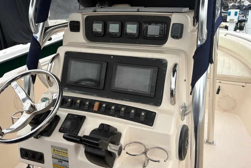 Slide: The Image of 2006 Grady-White Advance 257 boat dashboard with steering wheel and navigation controls. - 4
