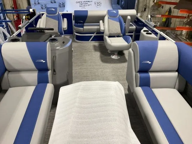 Slide: The Image of Interior of a 2025 Bennington S Swingback 22 SSB with blue and gray seating. - 6