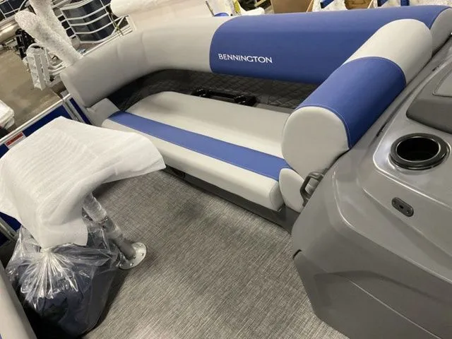 Slide: The Image of Interior of a Bennington S Swingback 22 SSB with blue and gray upholstery and a table. - 8