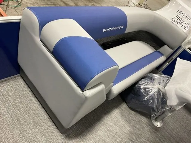 Slide: The Image of Bennington S Swingback 22 SSB 2025 with blue and gray upholstery on gray flooring. - 7