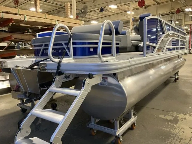 Slide: The Image of A Bennington pontoon boat, model S Swingback 22 SSB, is in a warehouse on dollies. - 4
