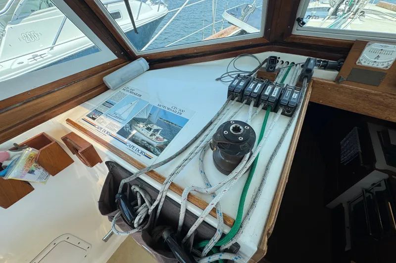 Slide: The Image of Interior view of a 1989 Cape Dory 30 Motorsailer cockpit with sailing equipment and brochures. - 23