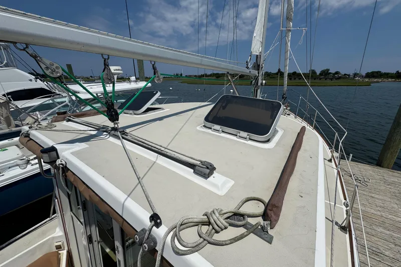 Slide: The Image of 1989 Cape Dory 30 Motorsailer docked, showcasing deck and rigging details. - 6
