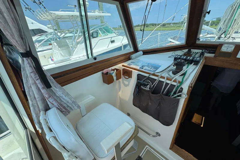 Slide: The Image of Interior view of 1989 Cape Dory 30 Motorsailer cockpit with helm and seating. - 13