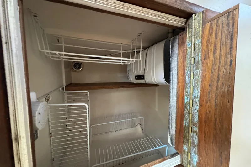 Slide: The Image of Interior view of a 1989 Cape Dory 30 Motorsailer refrigerator with wire shelving. - 37