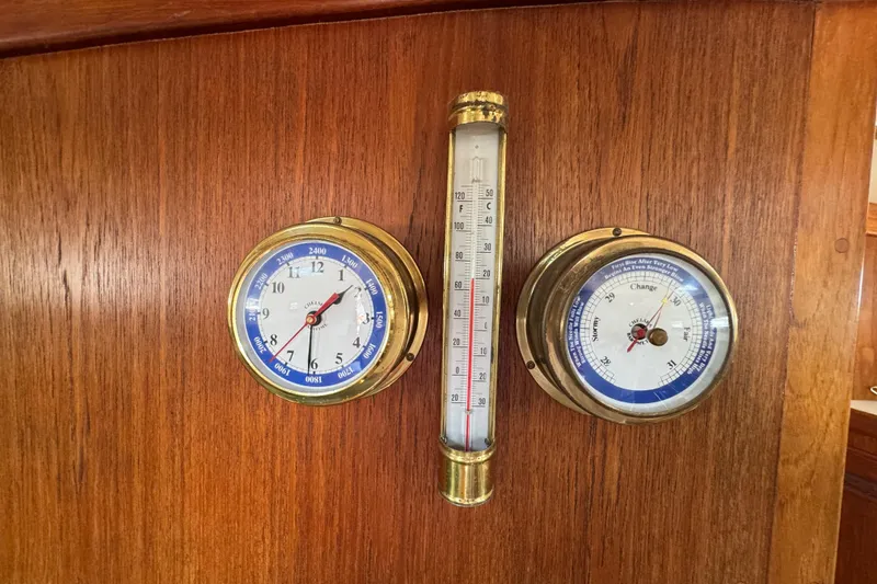 Slide: The Image of Nautical instruments on 1989 Cape Dory 30 Motorsailer, featuring clock, barometer, and thermometer. - 40