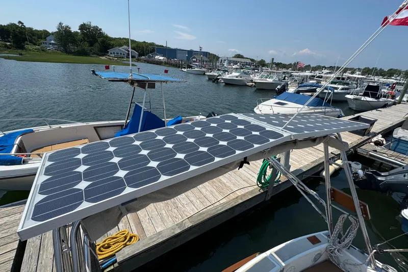 Slide: The Image of Cape Dory 30 Motorsailer with solar panels docked at a marina, 1989 model. - 46