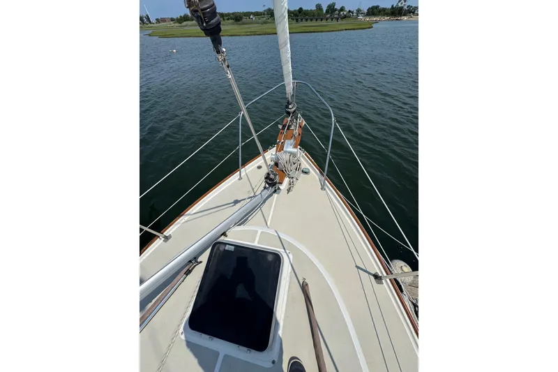 Slide: The Image of 1989 Cape Dory 30 Motorsailer deck view, sailing on calm waters. - 8