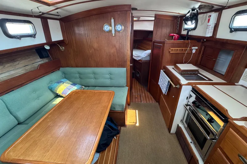 Slide: The Image of Interior of a 1989 Cape Dory 30 Motorsailer with wood finish and cozy seating area. - 25
