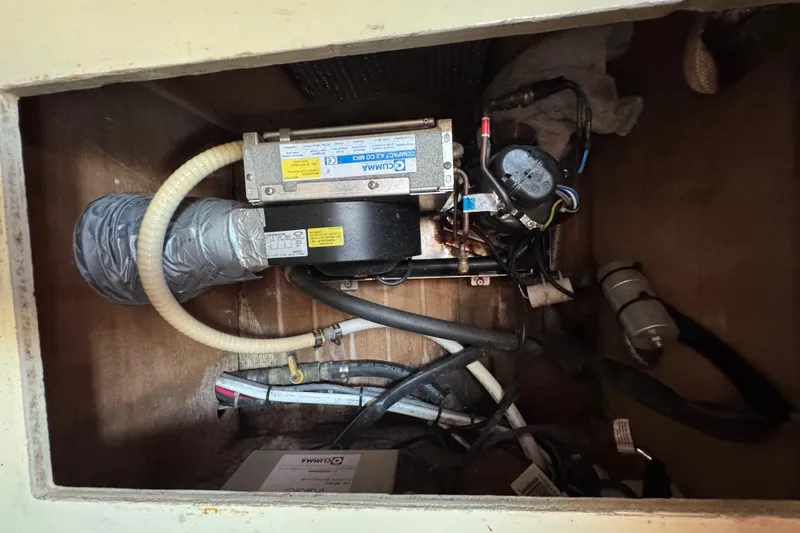 Slide: The Image of Electrical components inside a 1989 Cape Dory 30 Motorsailer, featuring wiring and ventilation. - 39
