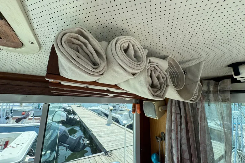 Slide: The Image of Interior of 1989 Cape Dory 30 Motorsailer with rolled canvas storage above window. - 18