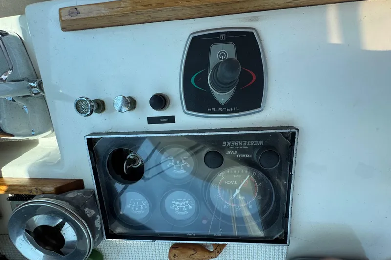 Slide: The Image of Control panel of a 1989 Cape Dory 30 Motorsailer with gauges and thruster controls. - 17