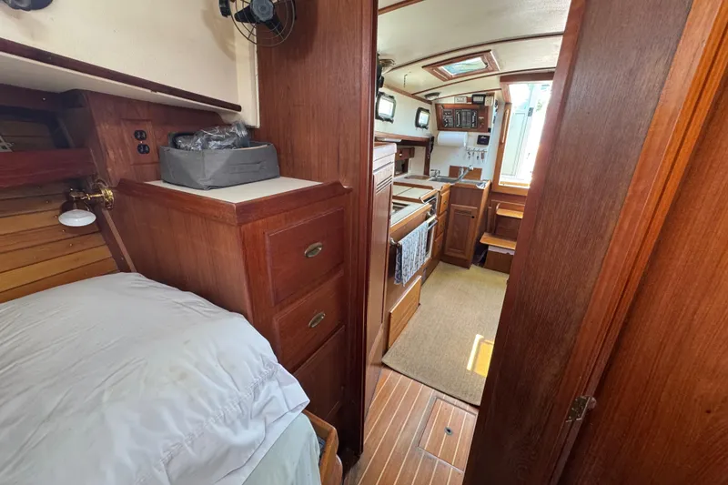 Slide: The Image of Interior of 1989 Cape Dory 30 Motorsailer with wood finish and compact kitchen. - 31