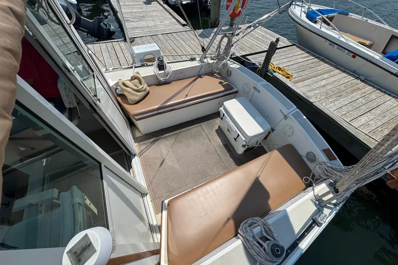 Slide: The Image of 1989 Cape Dory 30 Motorsailer cockpit with seating, cooler, and dock view. - 14