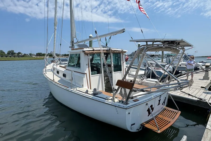 Slide: The Image of 1989 Cape Dory 30 Motorsailer docked, showcasing its classic design and sturdy build. - 2