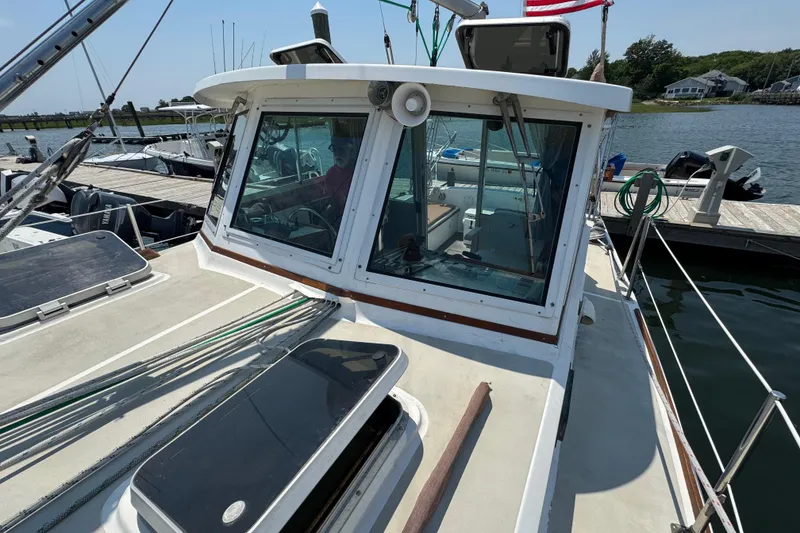 Slide: The Image of 1989 Cape Dory 30 Motorsailer docked, showcasing cabin windows and deck details. - 5