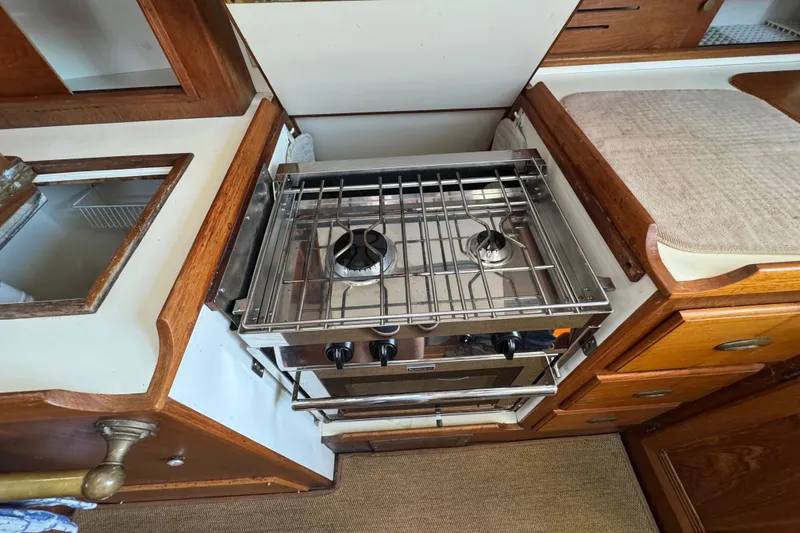 Slide: The Image of Compact kitchen area in a 1989 Cape Dory 30 Motorsailer with a two-burner stove. - 33