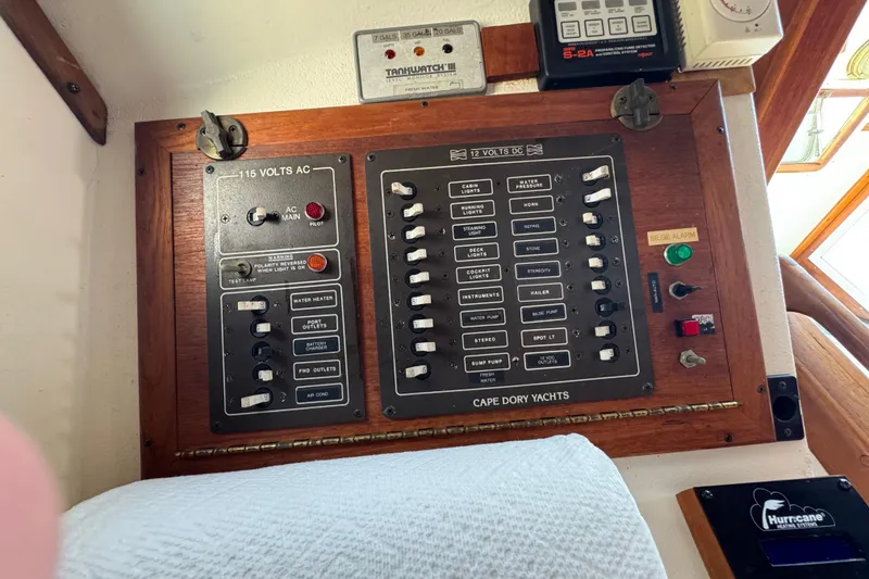 Slide: The Image of Electrical control panel on a 1989 Cape Dory 30 Motorsailer yacht, featuring AC and DC switches. - 38