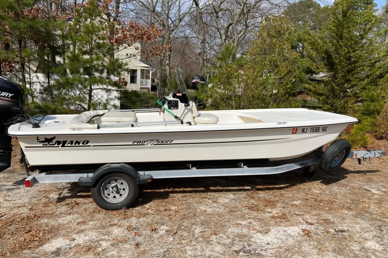 Slide: The Image of 2014 Mako Pro Skiff 17 CC boat on trailer, parked outdoors. - 1