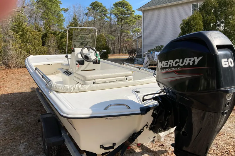 Slide: The Image of 2014 Mako Pro Skiff 17 CC boat with Mercury 60 outboard motor. - 2