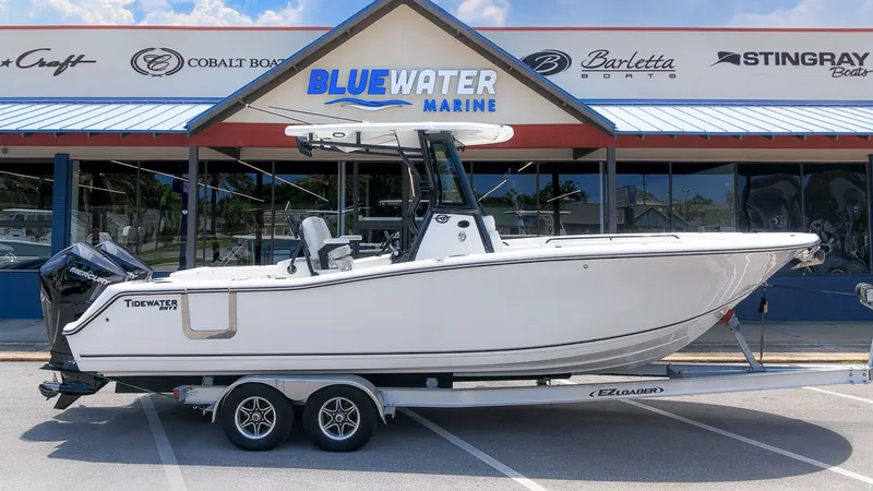 The Image of 2026 Tidewater 272 CC Adventure on a trailer in front of a boat dealership. - 1