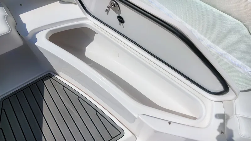 Slide: The Image of Close-up of a storage compartment on a Tidewater 272 CC Adventure boat, featuring gray flooring. - 32