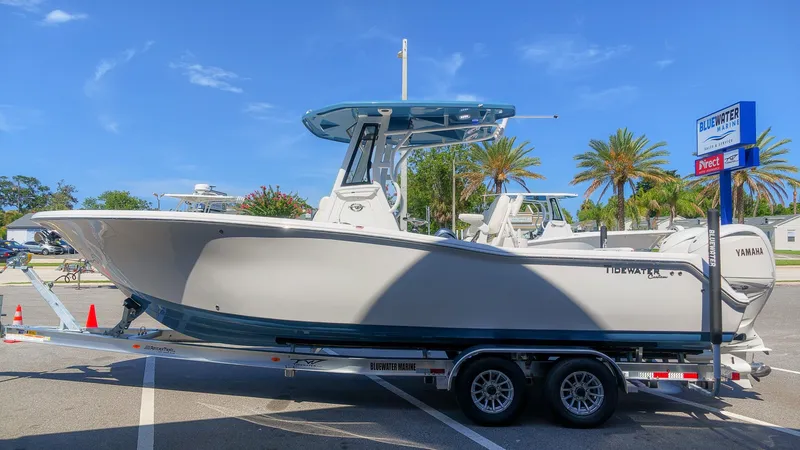 Slide: The Image of A 2027 Tidewater 272 CC Adventure boat on a trailer under a blue sky. - 5