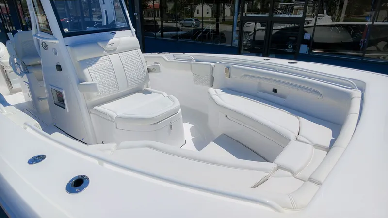 Slide: The Image of The image shows the cockpit of a Tidewater 272 CC Adventure boat with white upholstery. - 21