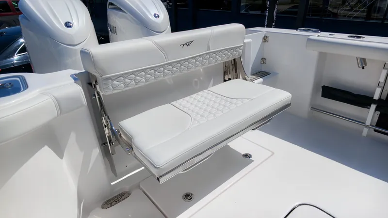 Slide: The Image of The 2027 Tidewater 272 CC Adventure features a sleek, white bench seat with a quilted pattern. - 12