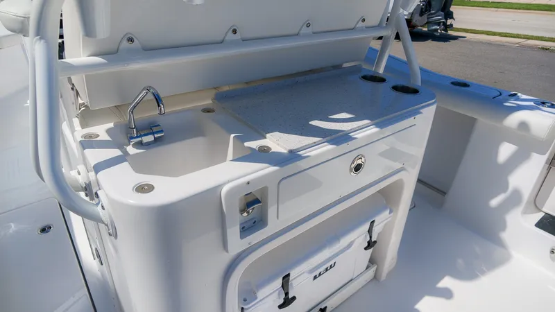 Slide: The Image of The 2027 Tidewater 272 CC Adventure features a well-equipped onboard kitchen with a sink and storage. - 16