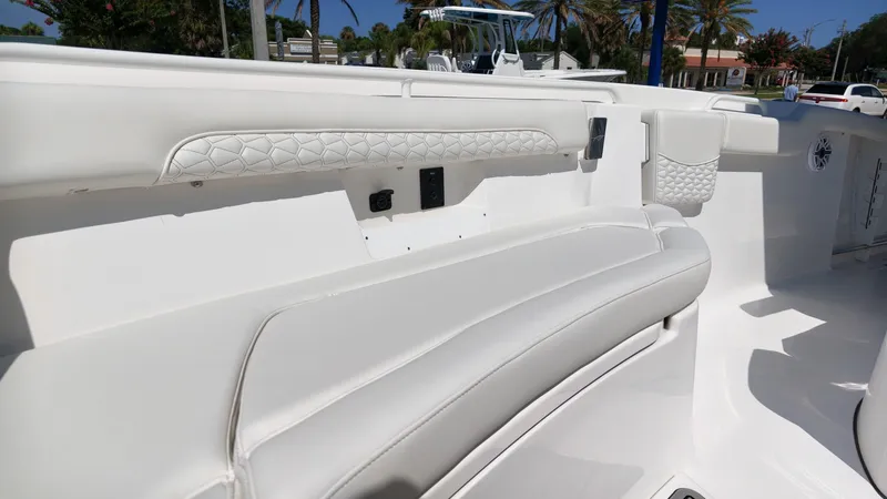 Slide: The Image of The image shows the white, cushioned seating area of a 2027 Tidewater 272 CC Adventure boat. - 31