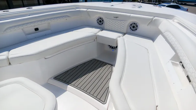 Slide: The Image of The image shows the bow area of a Tidewater 272 CC Adventure boat with white seating and speakers. - 27