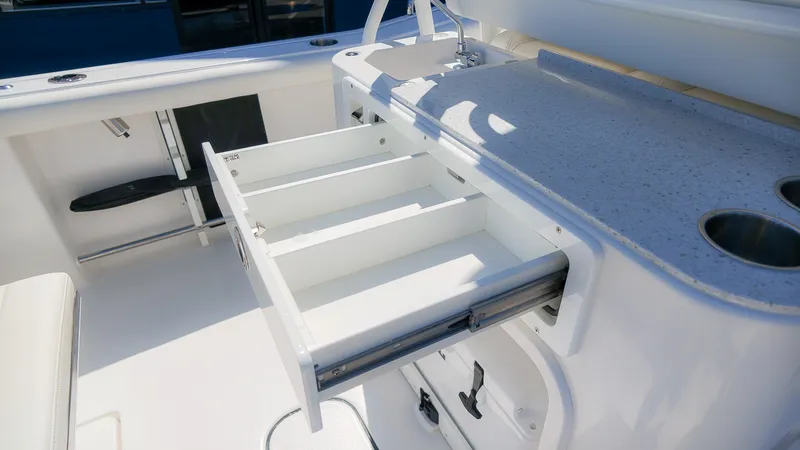 Slide: The Image of The 2027 Tidewater 272 CC Adventure features an open drawer in a white storage area. - 17