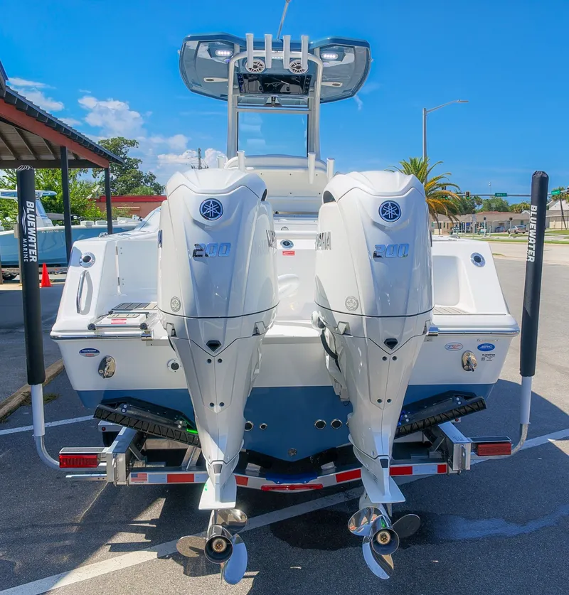 Slide: The Image of Two powerful outboard engines on a modern boat, resting on a trailer. - 6