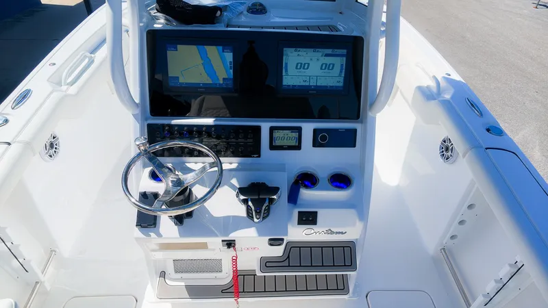 Slide: The Image of The image shows the helm of a Tidewater 272 CC Adventure boat with modern instruments and screens. - 23