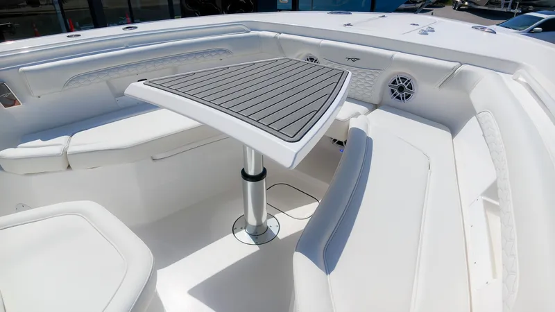 Slide: The Image of The image shows the seating area of a Tidewater 272 CC Adventure boat with a sleek table. - 29
