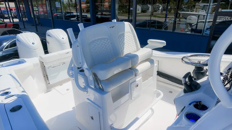 Slide: The Image of The image shows the cockpit of a 2027 Tidewater 272 CC Adventure boat with luxurious seating. - 19