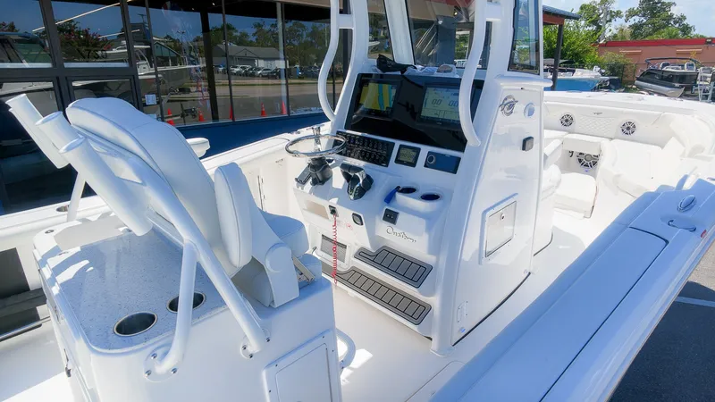 Slide: The Image of The image shows the cockpit of a 2027 Tidewater 272 CC Adventure boat with modern features. - 18
