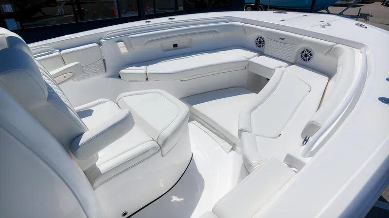 Slide: The Image of The image shows the cockpit of a Tidewater 272 CC Adventure boat with white upholstery and speakers. - 20