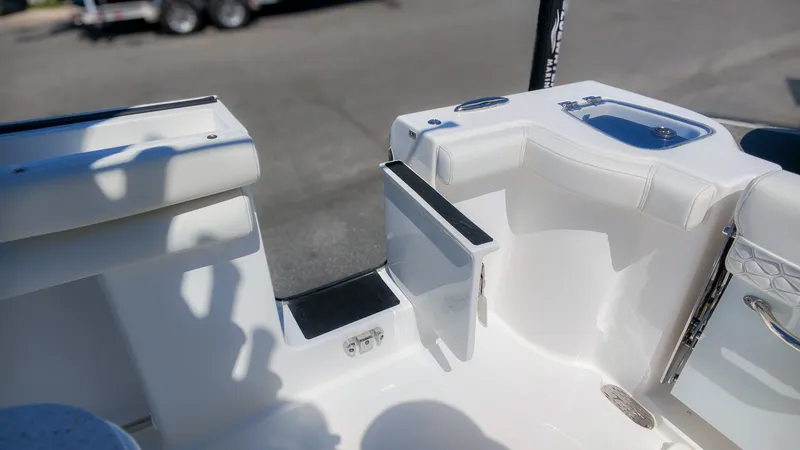 Slide: The Image of The image shows the cockpit of a Tidewater 272 CC Adventure boat with white upholstery and a sink. - 9