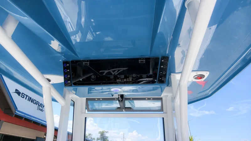 Slide: The Image of The image shows the blue roof of a Tidewater 272 CC Adventure boat with an integrated speaker system. - 22