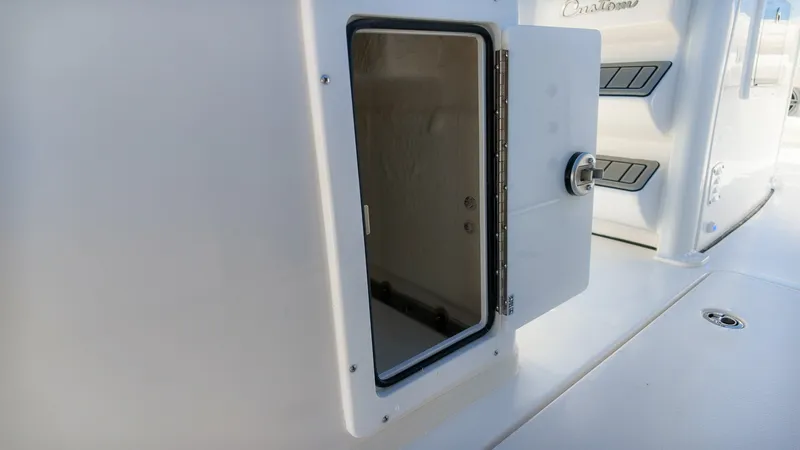 Slide: The Image of An open storage compartment on a 2027 Tidewater 272 CC Adventure boat. - 15