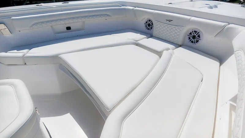 Slide: The Image of The image shows the white seating area of a Tidewater 272 CC Adventure boat with speakers. - 30
