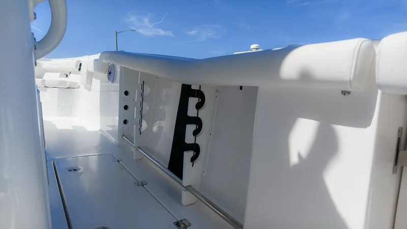 Slide: The Image of The image shows the deck of a Tidewater 272 CC Adventure boat with white upholstery and rod holders. - 8