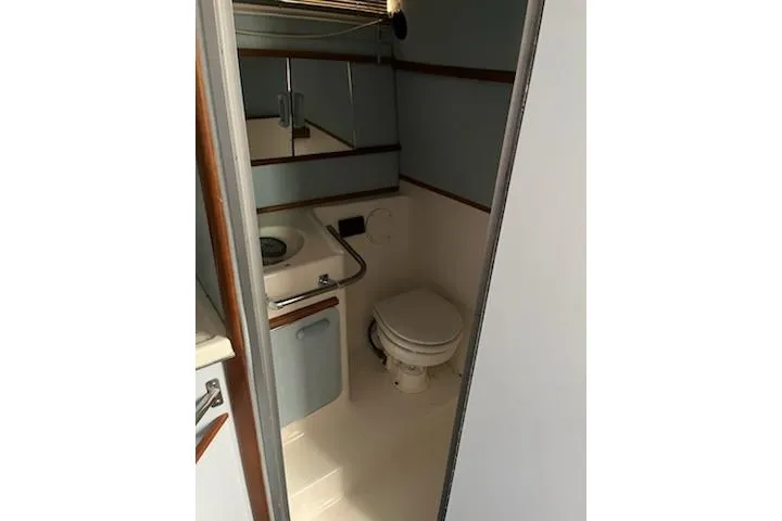 Slide: The Image of Bathroom interior of 1989 Sea Ray 300 Sundancer yacht, featuring sink and toilet. - 4