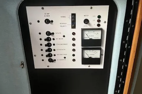 Slide: The Image of Control panel of a 1989 Sea Ray 300 Sundancer boat with gauges and switches. - 7
