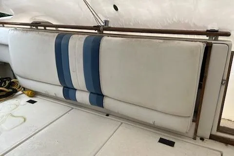 Slide: The Image of 1989 Sea Ray 300 Sundancer interior with blue-striped seating and white upholstery. - 9