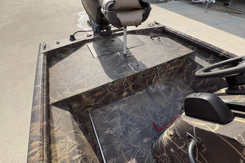 Slide: The Image of 2018 Excel 1854 Shallow Water F4 Console boat interior with camouflage design and steering console. - 15