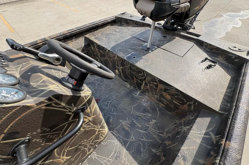 Slide: The Image of 2018 Excel 1854 Shallow Water F4 Console boat interior with camouflage design and steering wheel. - 16