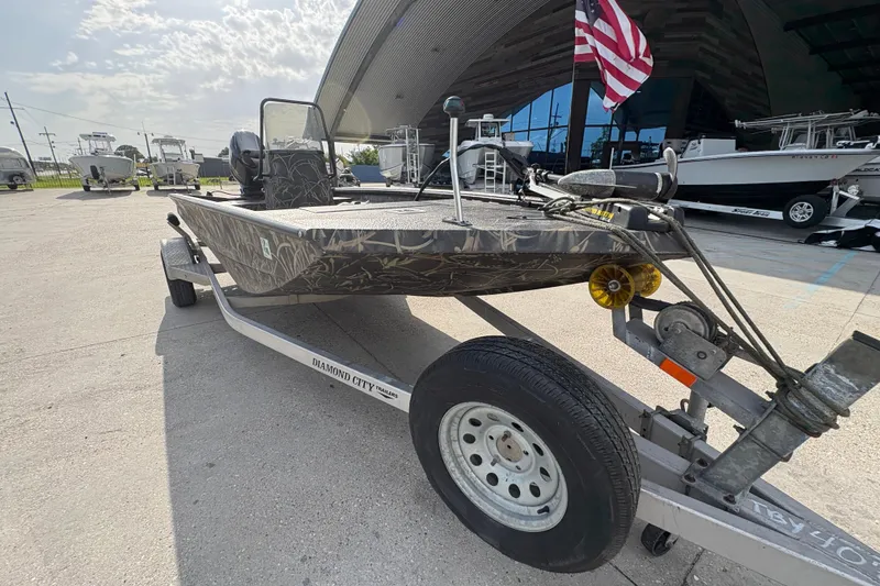 Slide: The Image of 2018 Excel 1854 Shallow Water F4 Console boat on trailer, parked outdoors. - 9